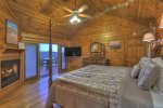 Master Bedroom on the Main Floor with a King Bed Flat Screen TV and Gas Log Fireplace